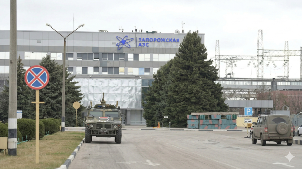 An aerial view of the Zaporizhzhia Nuclear Power Plant in Ukraine, showing the cooling towers and reactor buildings under a clear sky.